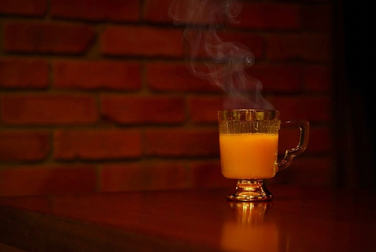 湯気の立つホットカクテル「ホット・イタリアーノ」。アマレットと温かいオレンジジュースを使ったBAR ALBAの冬のおすすめカクテル。